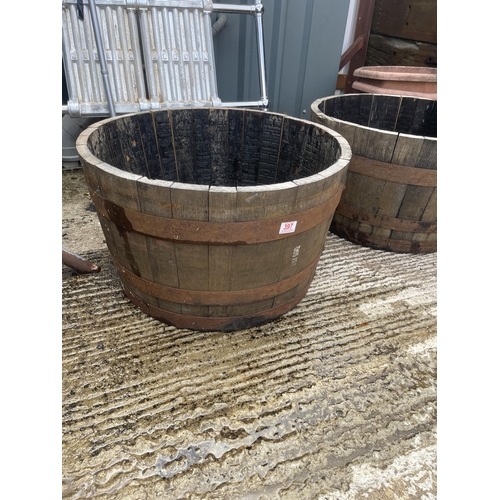 447 - A pair of Scottish oak half whiskey barrel planters 2ft round