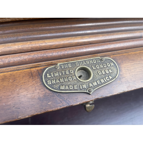 42 - A large good quality American walnut patent roll top desk with fitted interior and 9 locking drawers... 