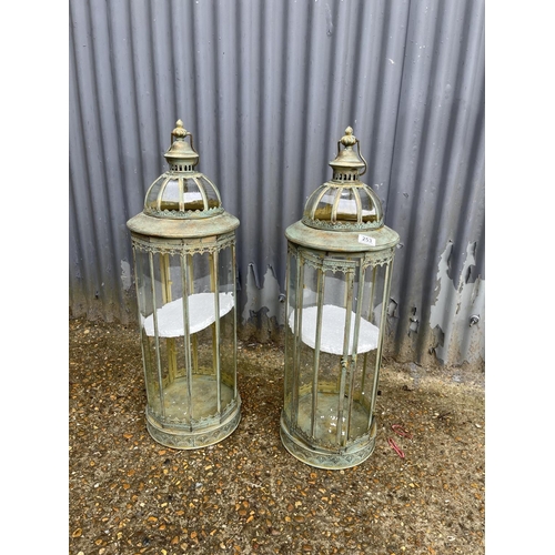 50F - A pair of copper and glass tall candle lanterns 87cm