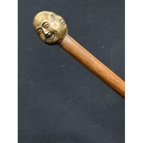 1034 - A four face Brass Buddha topped walking stick