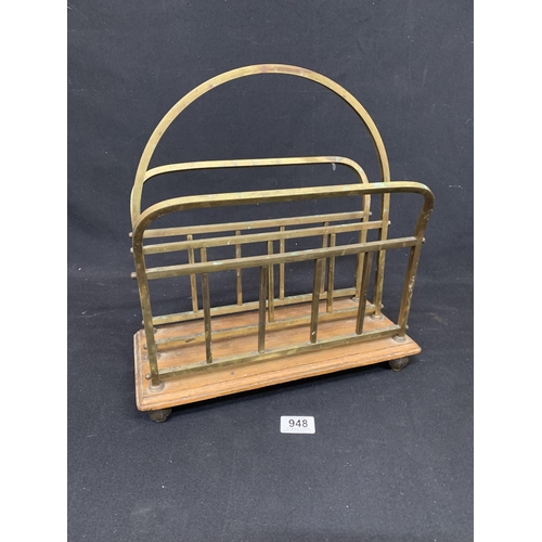 948 - Edwardian brass and oak magazine rack on four brass feet, height 37 cms