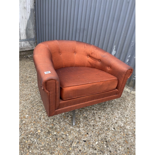 104 - A mid century g plan red upholstered swivel tub chair on star form base