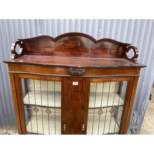 106 - An Edwardian mahogany display cabinet with leaded bow glass doors  107x 30x172