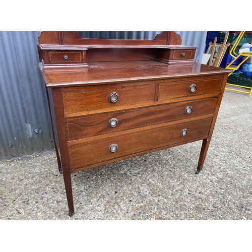 111 - An Edwardian mahogany four drawer dressing chest with swing mirror