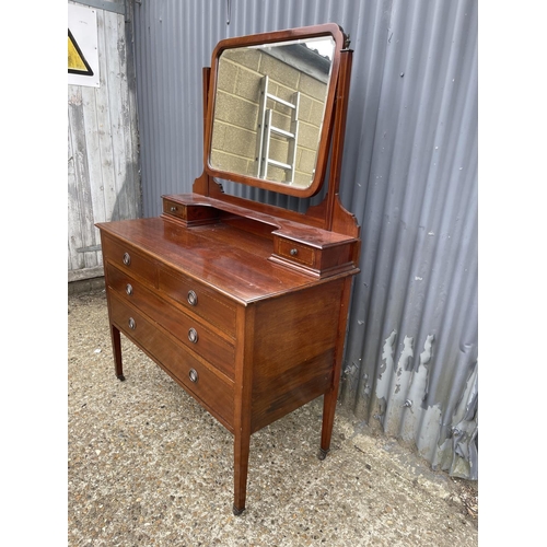 111 - An Edwardian mahogany four drawer dressing chest with swing mirror