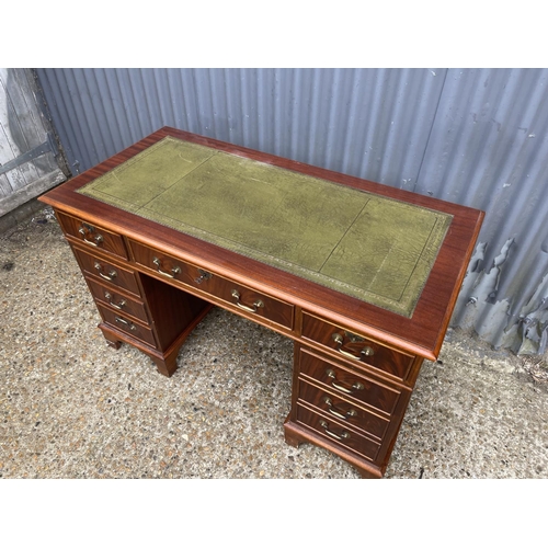 113 - A reproduction mahogany twin pedestal desk with a green leather top, size 120 x 60 cms