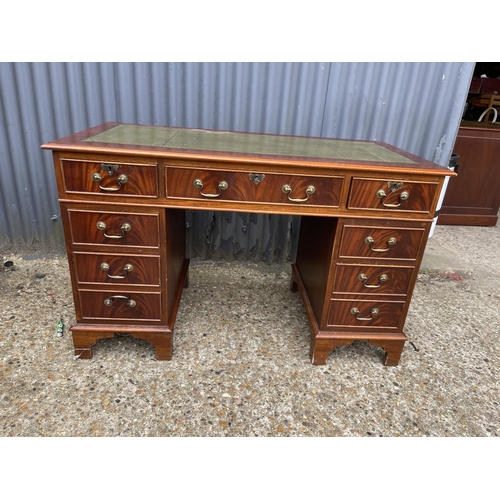 113 - A reproduction mahogany twin pedestal desk with a green leather top, size 120 x 60 cms