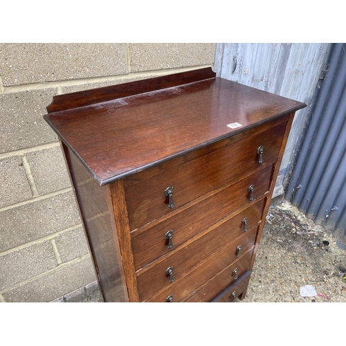 139 - An oak tallboy chest of six drawers