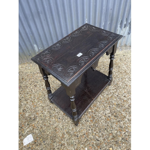 142 - A carved oak occasional table