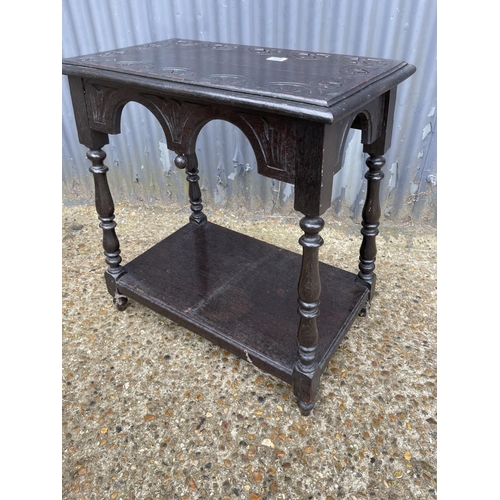 142 - A carved oak occasional table