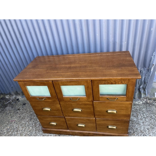 147 - A modern 9 drawer chest with brass cup handles 110x50x90