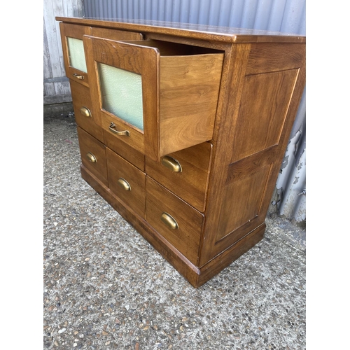 147 - A modern 9 drawer chest with brass cup handles 110x50x90