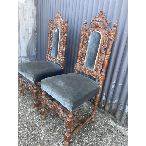 149 - A pair of carved oak chairs with blue upholstery