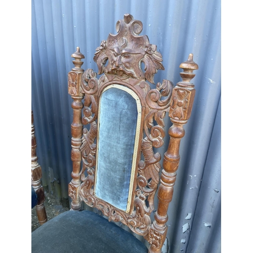 149 - A pair of carved oak chairs with blue upholstery