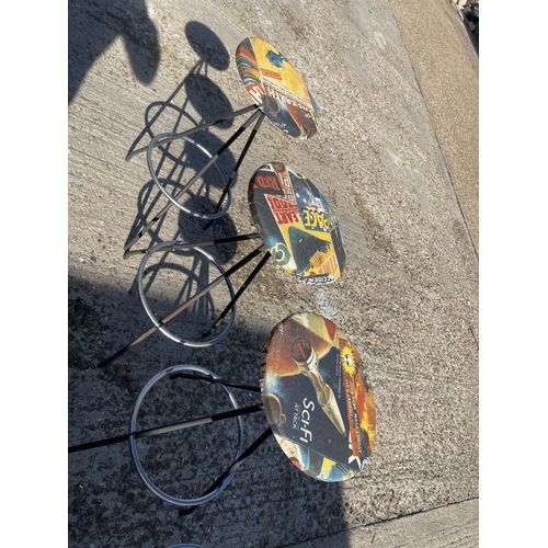 153 - A set of four chrome bar stools upholstered with MARVEL patterns to the seats