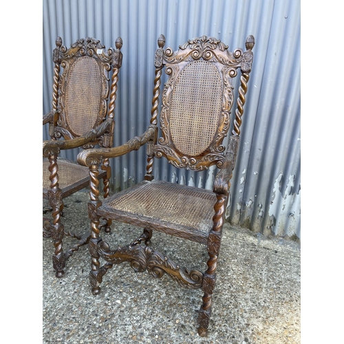 157 - A pair of carved oak throne style carver chairs with begere seats