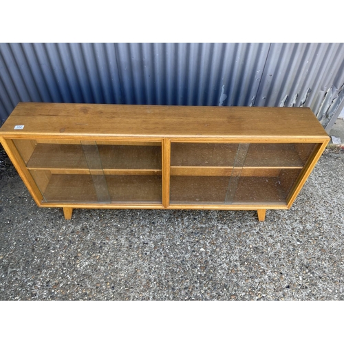 162 - A light oak double sided glazed bookcase 150cm