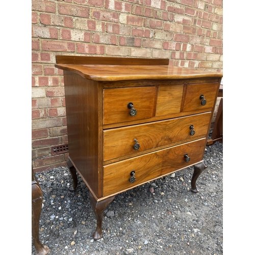 17 - A Queen Anne style walnut chest of drawers and matching dressing table