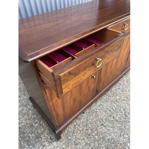 199 - A stag minstrel three drawer and three door sideboard