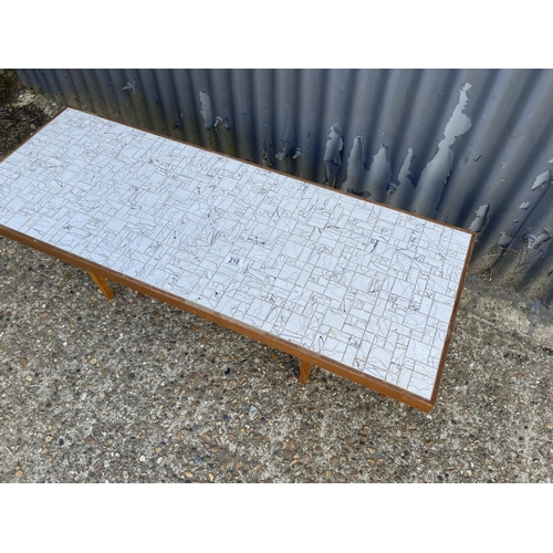 210 - A teak coffee table with mosaic top