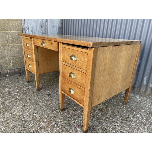 254 - An early 20th century oak twin pedestal desk