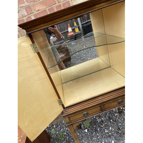 27 - A reproduction mahogany drinks cabinet