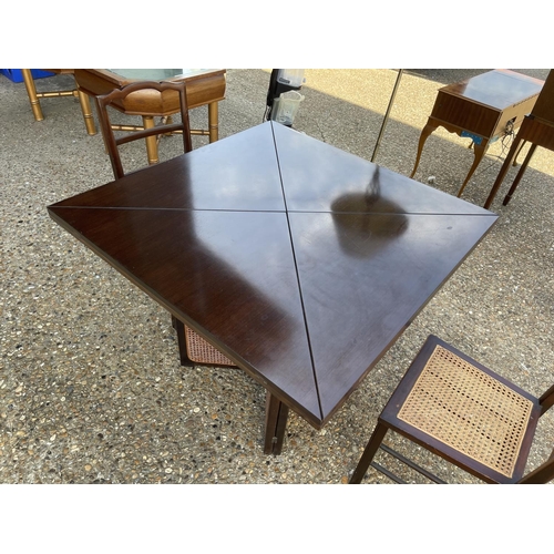 271 - A begere and hardwood square dining table with envelope fold out extensions, together with two beger... 