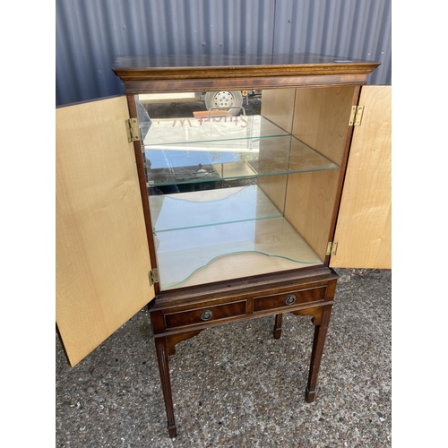 273 - A reproduction mahogany drinks cabinet with glass interior