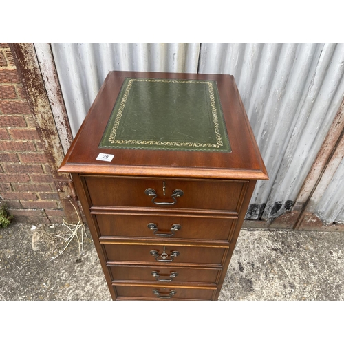 29 - A reproduction mahogany three drawer filing cabinet with green leather top