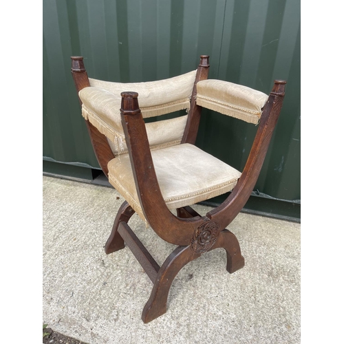 291 - An oak x frame throne chair