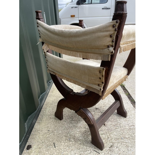 291 - An oak x frame throne chair