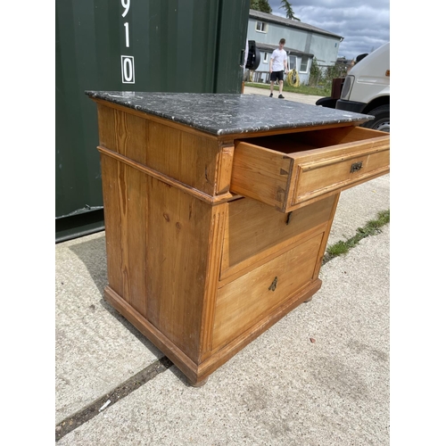 294 - A continental pine chest of three with grey marble top 77x55x89