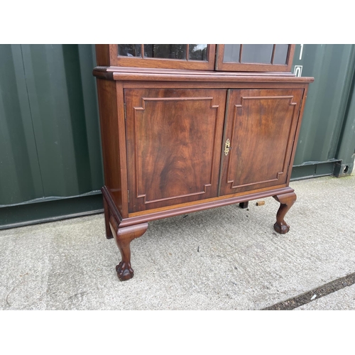 298 - A victorian mahogany two door cabinet on two door cupboard base  92x50x207