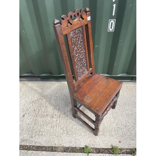 310 - A carved oak panel back chair