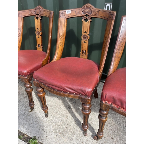 313 - A set of four victorian dining chairs with red leather upholstered seats