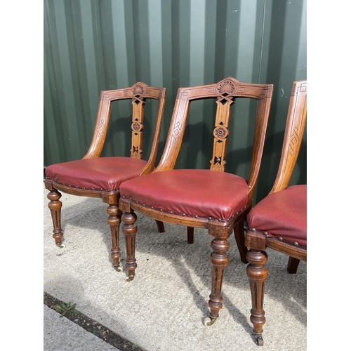 313 - A set of four victorian dining chairs with red leather upholstered seats