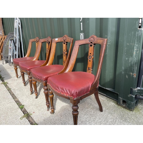 313 - A set of four victorian dining chairs with red leather upholstered seats