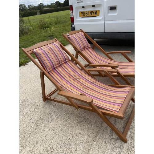 350 - A pair of hardwood deck chairs with striped seats