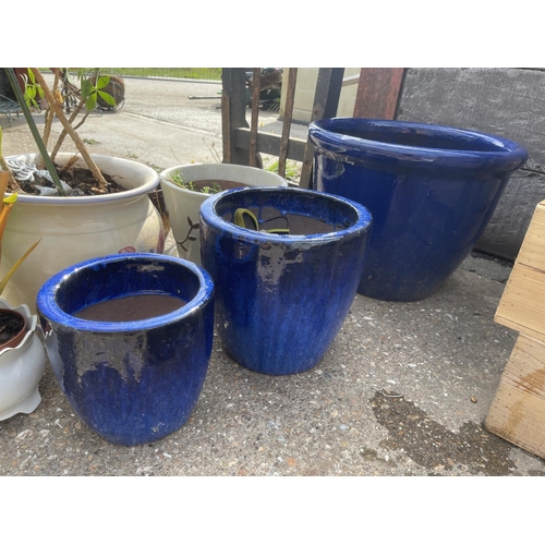 383 - A graduated set of three blue glazed garden planters