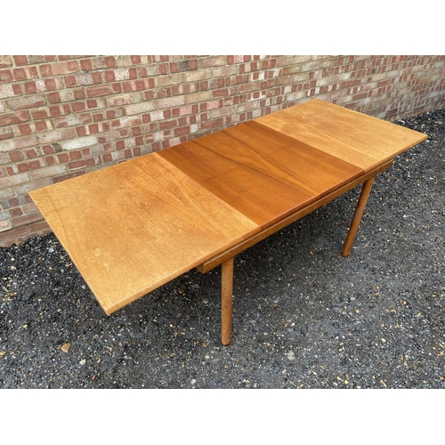 4 - A mid century teak extending dining table by White and Newton