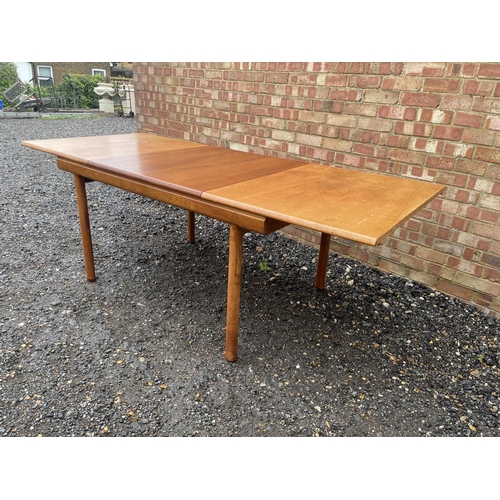 4 - A mid century teak extending dining table by White and Newton