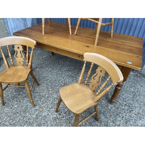 51 - A solid pine farmhouse style table together with four pine chairs 183x90