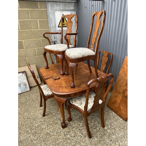 52 - A walnut ball and claw wind out extending dining table with one leaf and a set of six matching ball ... 