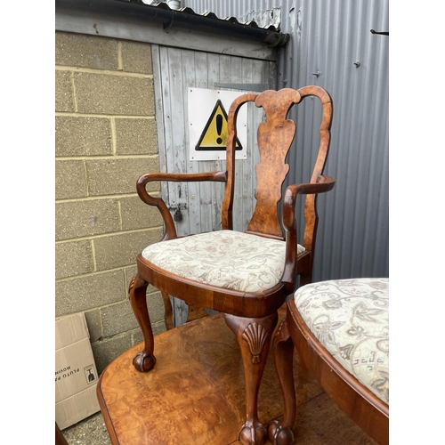 52 - A walnut ball and claw wind out extending dining table with one leaf and a set of six matching ball ... 