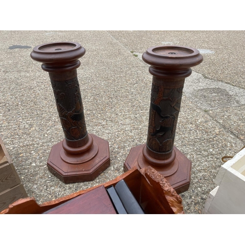 94 - A pair of carved stands, two wooden boxes and a collection of wooden cases