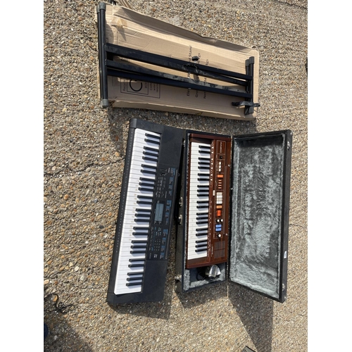 123 - Two Casio keyboards and two folding stands