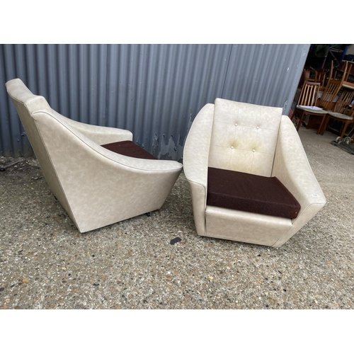 135 - A pair of mid century white vinyl armchairs