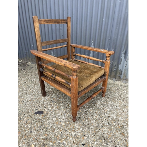 139 - An oak bed chair with folding back