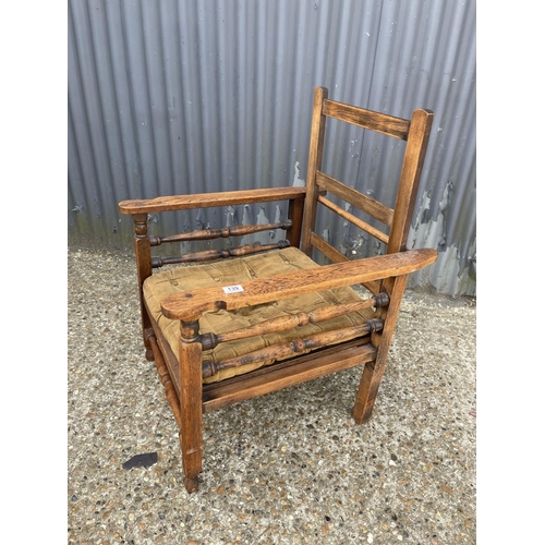 139 - An oak bed chair with folding back