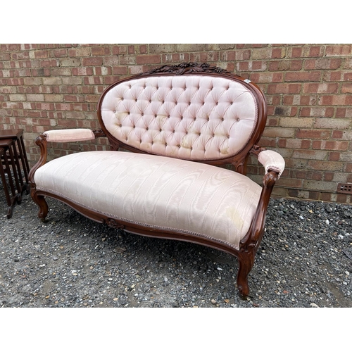 14 - A french style salon love seat with pink buttoned upholstery and decorative mahogany frame